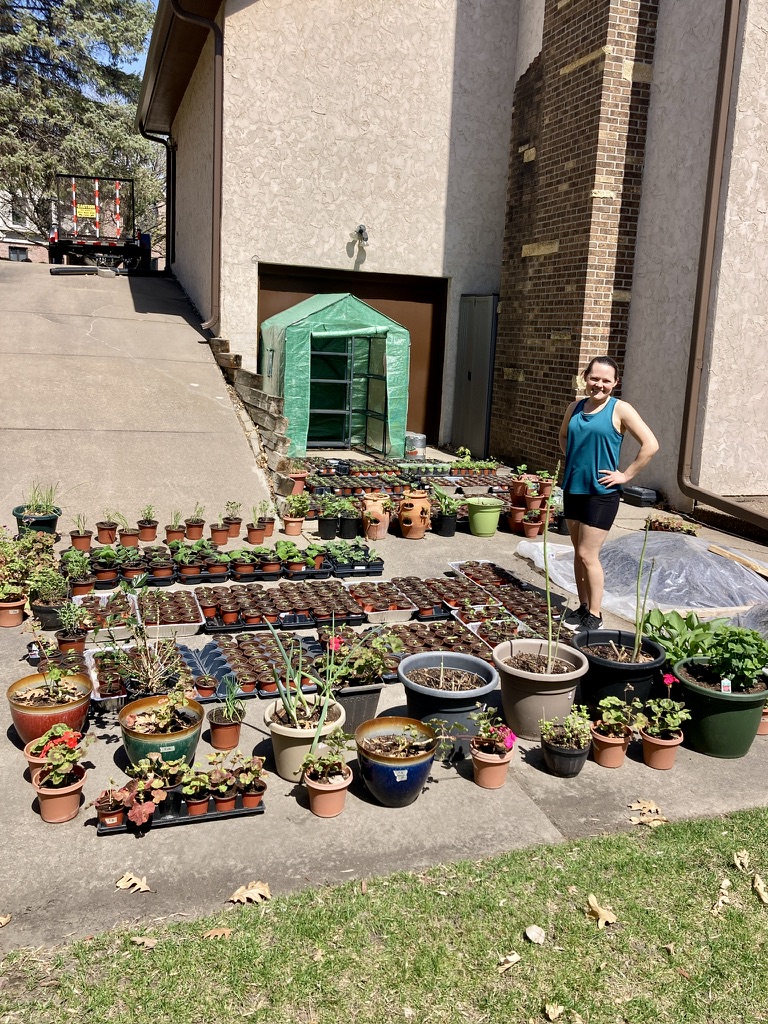 Sara with her plants on the driveway